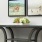 hallway with a floral centerpiece on a table under framed pictures on the wall