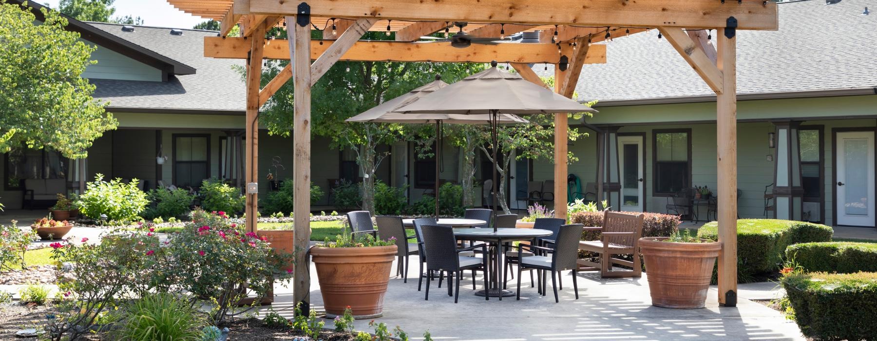 outdoor patio with pergola covered tables and chairs